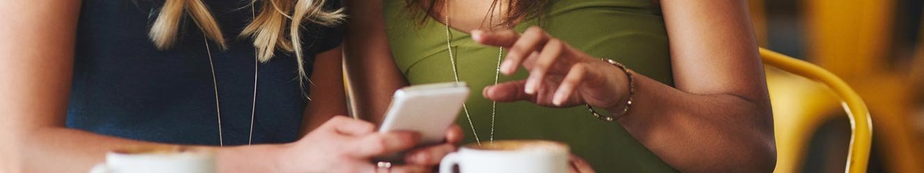 Friends talking about something they saw on their phone.